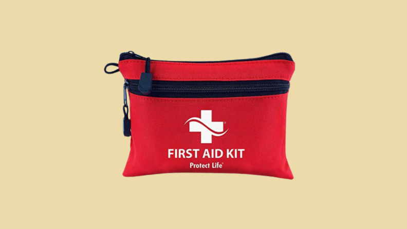 First aid kit against tan background