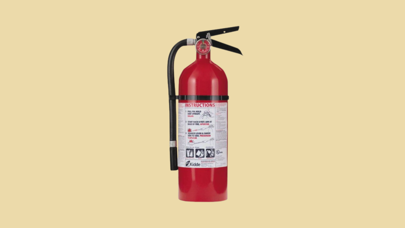 Fire extinguisher against tan background