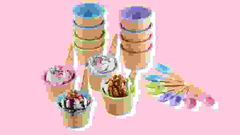 Several colorful ice-cream themed cups and bowls on a pink background