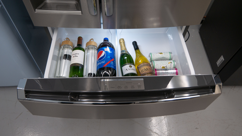 One of the Frigidaire draws is open with beverages inside.