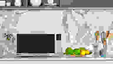 Panasonic's first smart microwave sitting on a kitchen counter with a marble backsplash