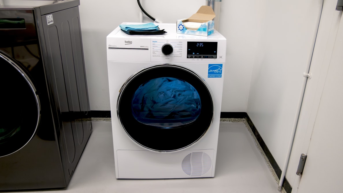 The Beko HPD24414W dryer next to another machine in a white room.