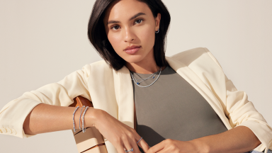 An image of a woman with two diamond rings on her fingers, one on her ring finger.