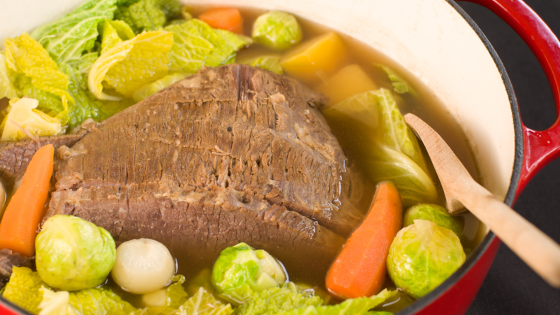 A pot of corned beef and cabbage cooked in a Dutch oven.