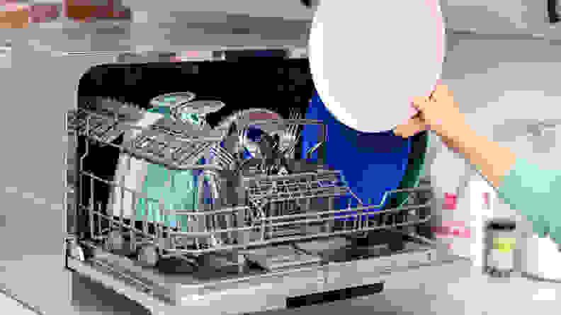 Countertop dishwashers can usually fit up to six place settings, which includes one plate, one bowl, one glass, one fork, one spoon, and one knife.