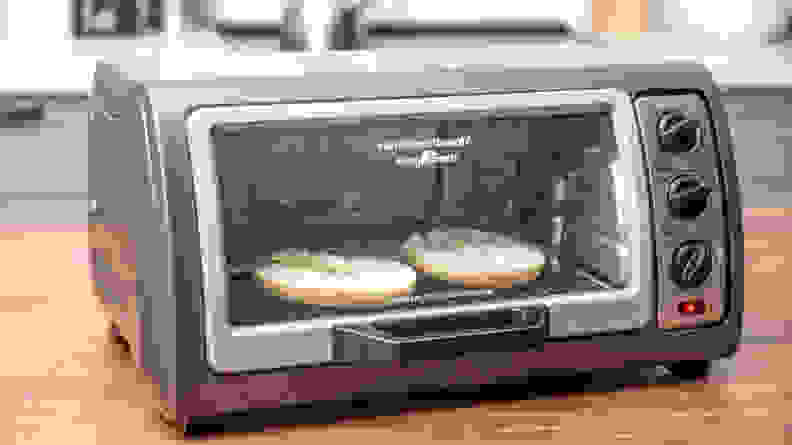 Bagel toasting in a toaster oven.