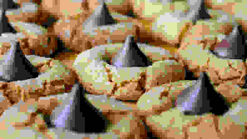 Peanut butter blossom cookies on cutting board, macro view of rows of cookies