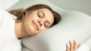 Woman sleeping on Cushion Lab deep sleep pillow