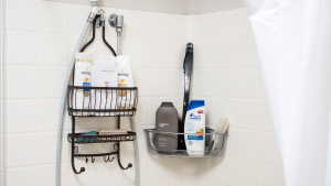 Shower caddies hanging on a shower wall with soap bottles