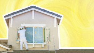 Painter on roof painting exterior of home above window.