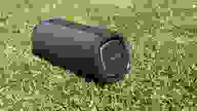 A black LG XBoom Go on a patch of grass.