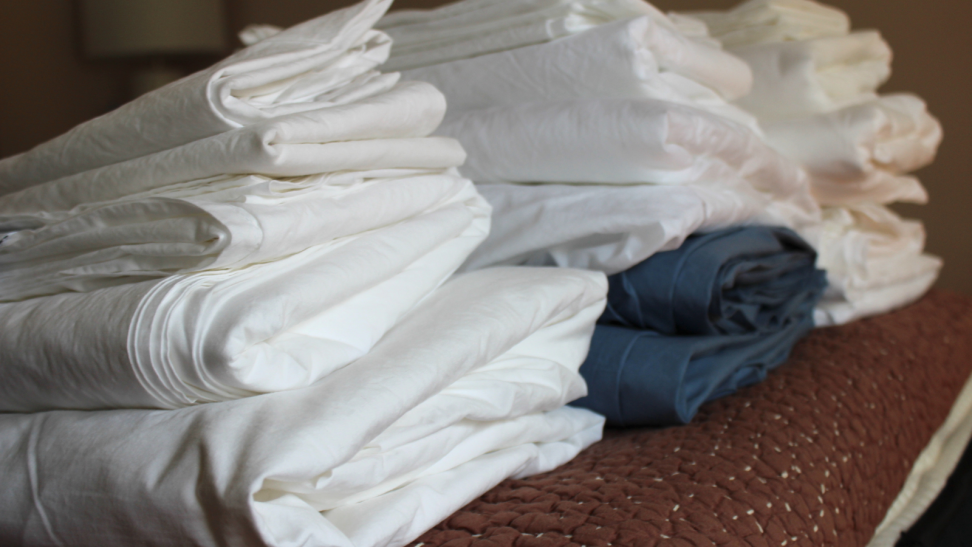 Three stacks of percale sheets