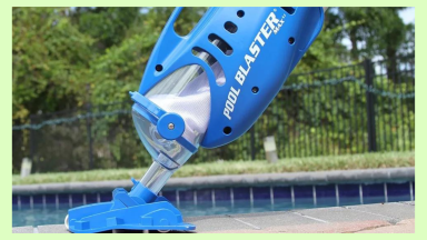 A home owner cleaning their backyard pool with a pool vacuum.