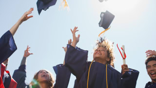 Graduates throwing their hats in the air